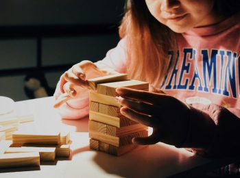 A young girl playing Jenga